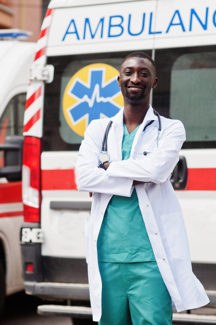 A doctor standing in front of an ambulance.